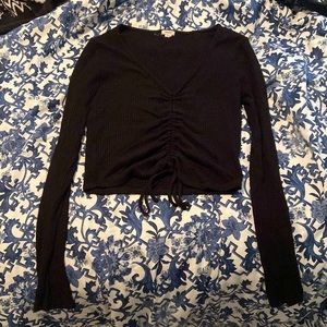 Black full length long sleeved top from Garage. The bottom is ruched & has a tie